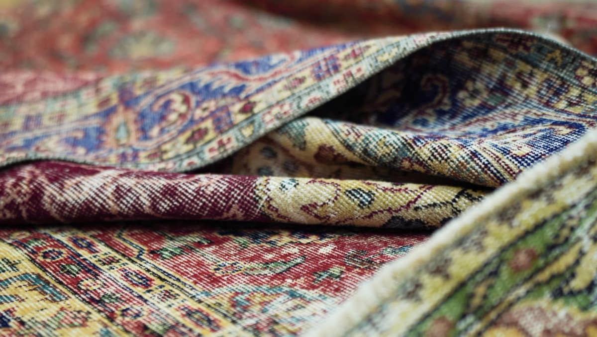 Close-up of a handwoven Anatolian rug showing wool pile and traditional pattern